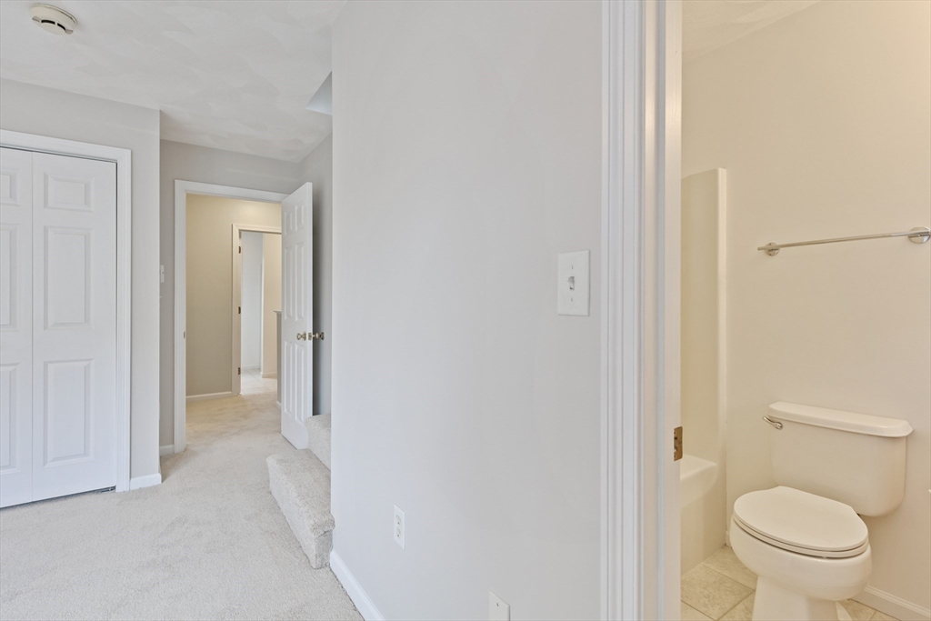 555 Main Street, Unit 10 Woburn, MA 01801 - Photo 24 of 39 a bathroom with a toilet and a sink