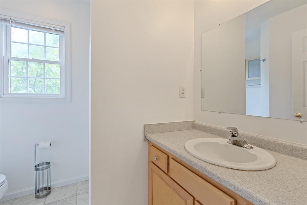 555 Main Street, Unit 10 Woburn, MA 01801 - Photo 25 of 39 a bathroom with a sink and a mirror