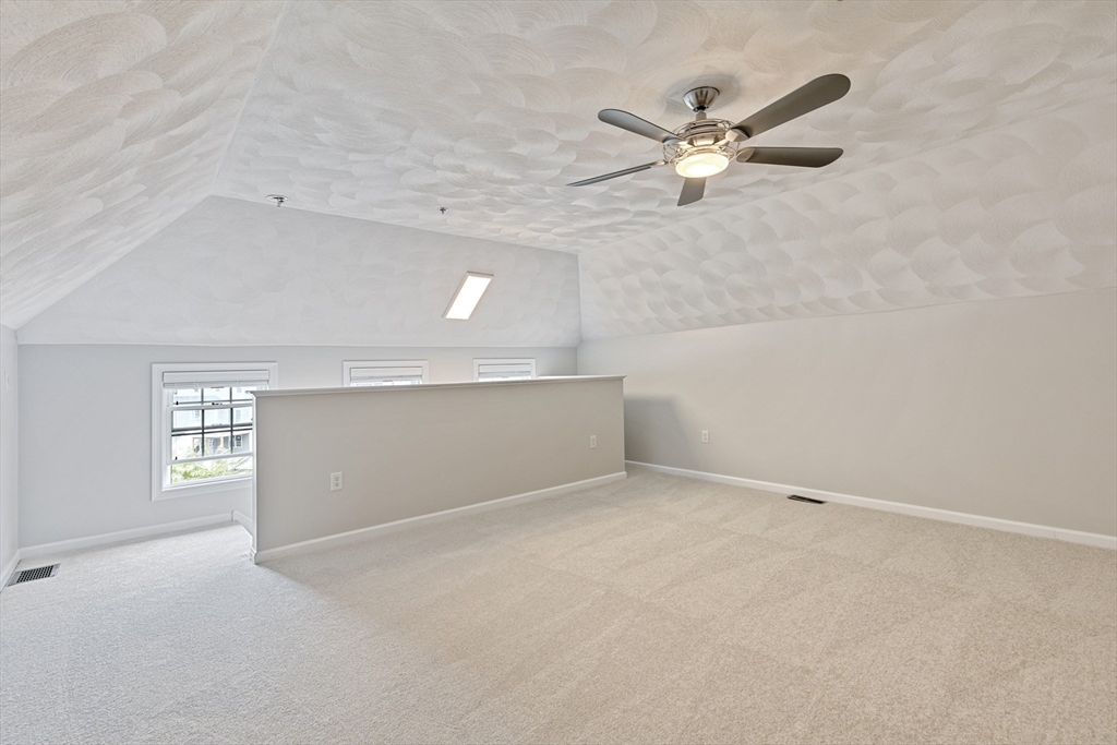 555 Main Street, Unit 10 Woburn, MA 01801 - Photo 30 of 39 an empty room with windows and fan