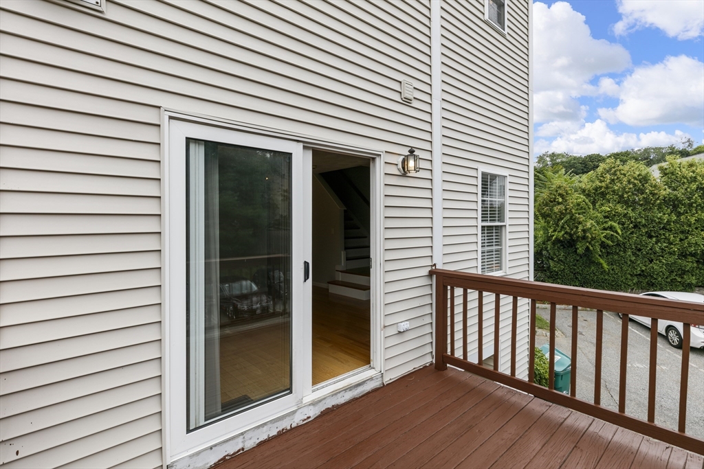 555 Main Street, Unit 10 Woburn, MA 01801 - Photo 36 of 39 a view of a porch with a door and wooden floor