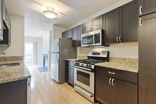 a view of a kitchen with a sink and a refrigerator