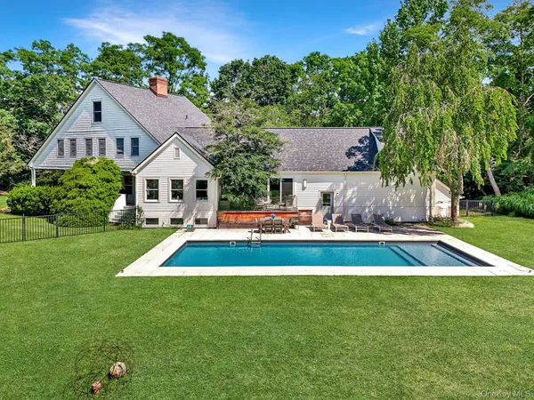 a aerial view of a house with a yard table and chairs