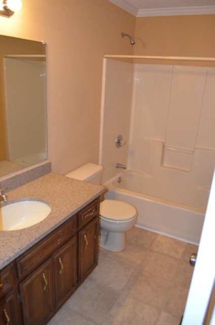 1689 Johnson Road Macon, GA 31220 - Photo 5 of 17 a bathroom with a granite countertop sink toilet and shower