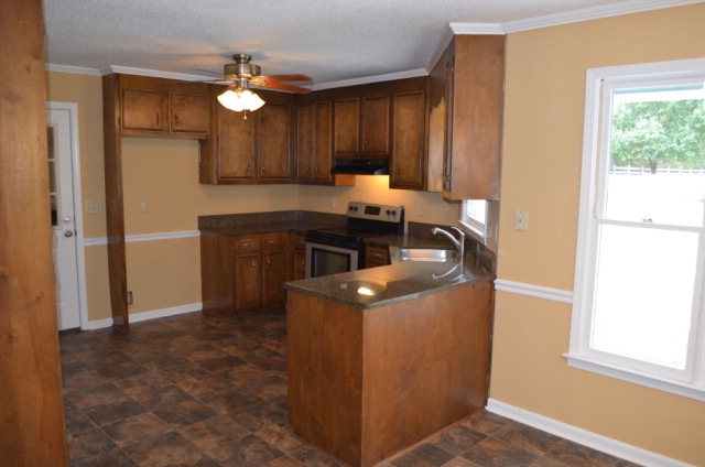 1689 Johnson Road Macon, GA 31220 - Photo 6 of 17 a kitchen with a stove and a refrigerator