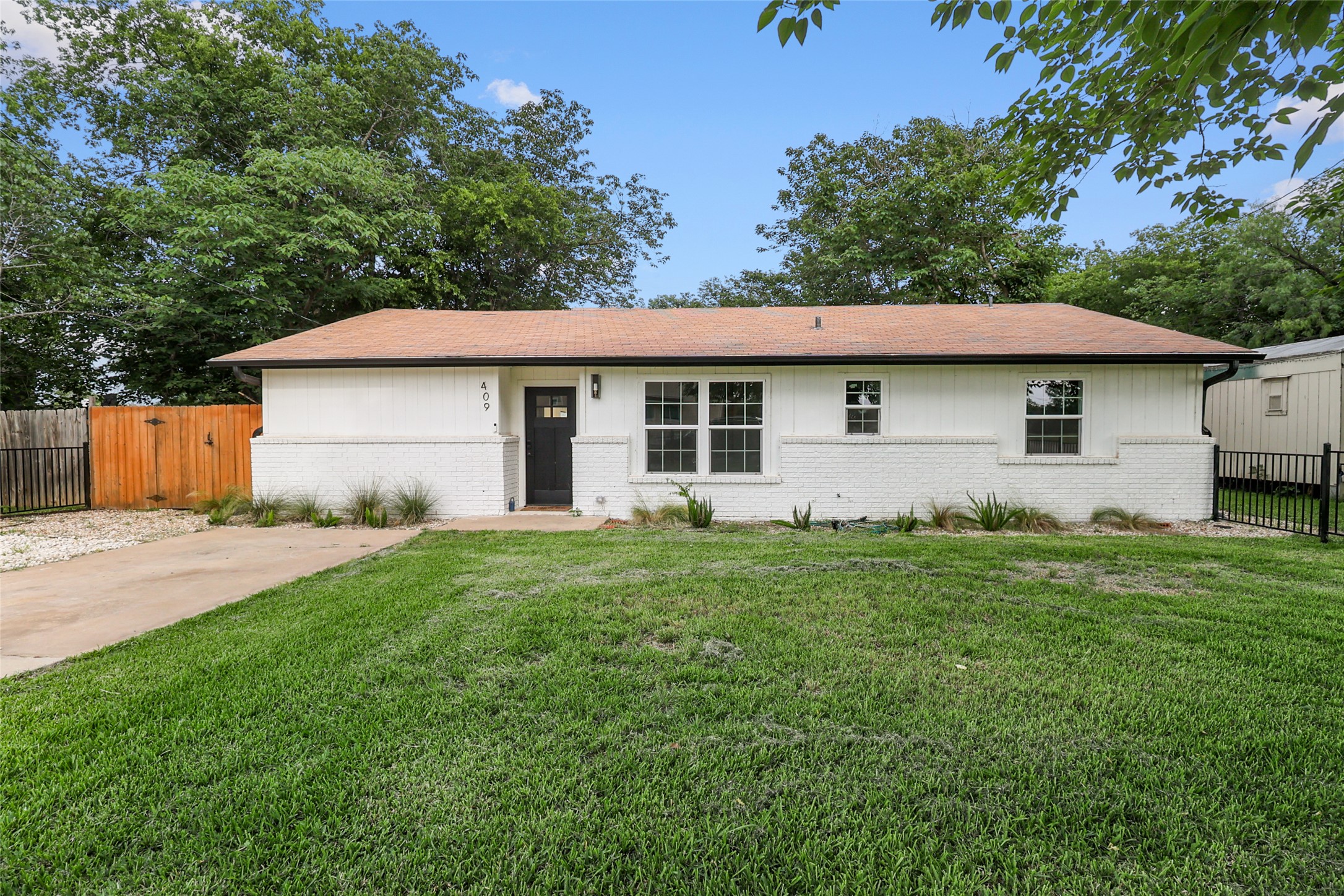 409 Ave R Marble Falls, TX 78654 - Photo 2 of 25 Ranch-style residence featuring a white brick and horizontal siding exterior