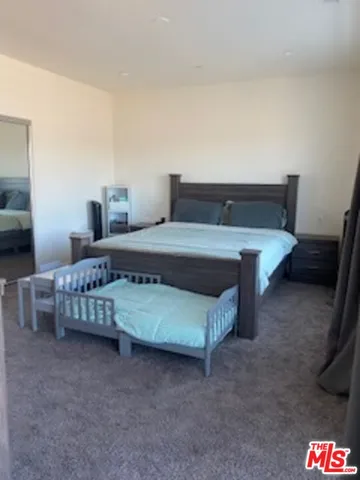 a bedroom with a bed and a couch