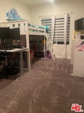 a view of a livingroom with furniture and a flat screen tv