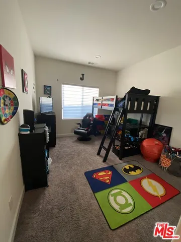 a room with gym equipment and a flat screen tv