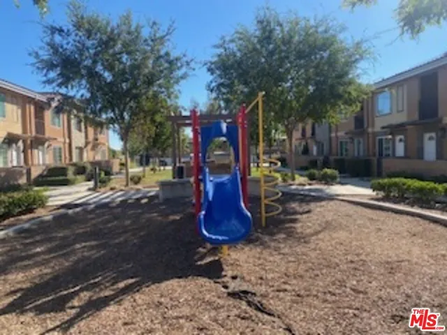a view of a park with swings and slides