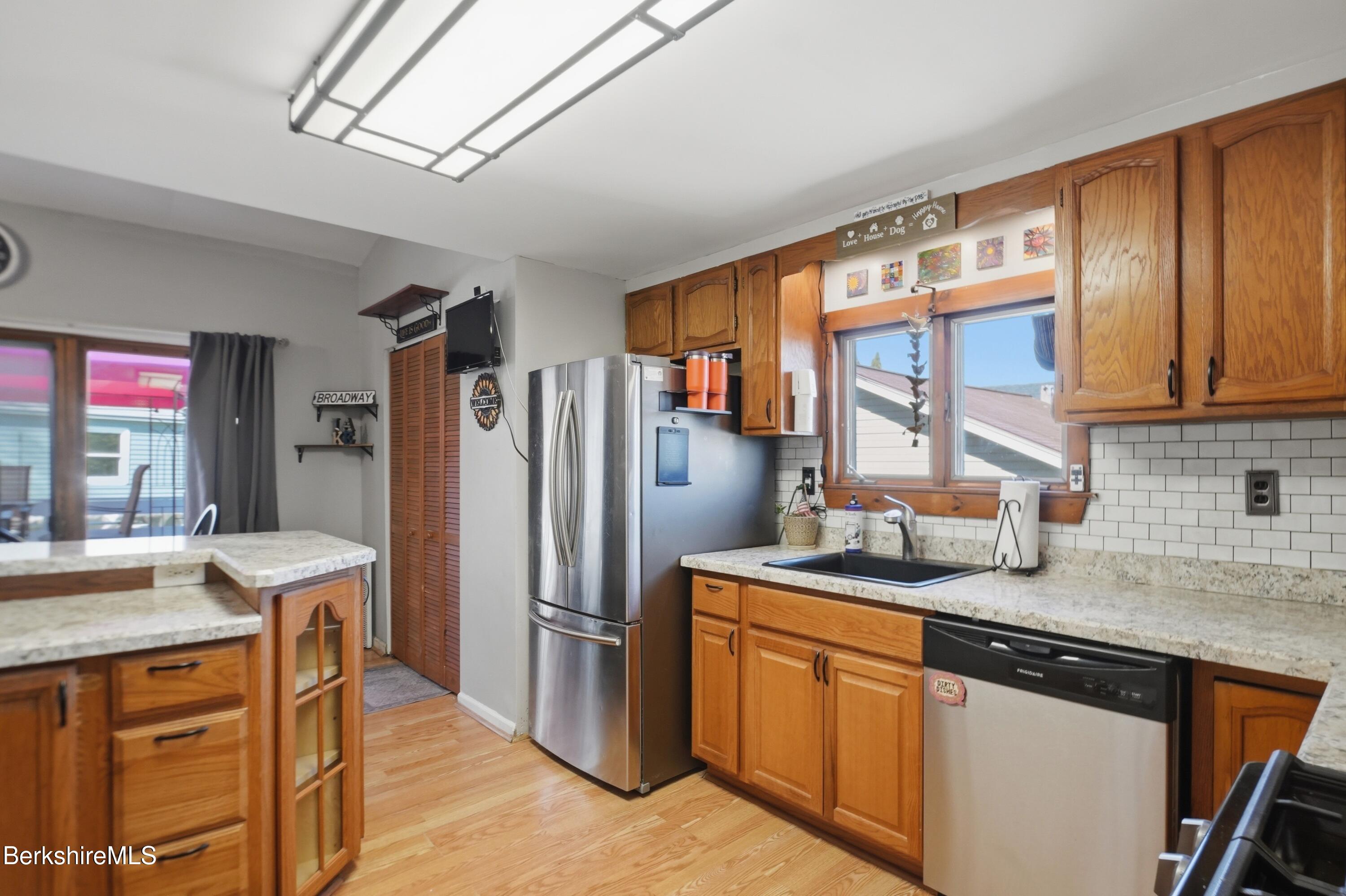 22 Broadway Street Pittsfield, MA 01201 - Photo 51 of 84 a kitchen with stainless steel appliances granite countertop a refrigerator and a sink