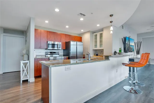 a dining room with furniture a chandelier and wooden floor