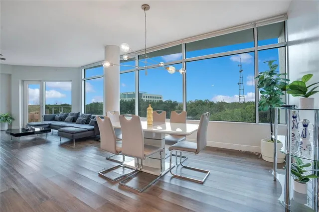 a view of a living room with furniture and floor to ceiling windows