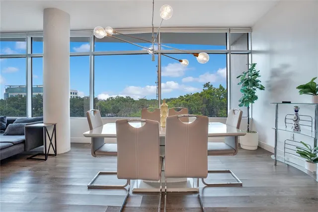 a dining room with furniture and wooden floor