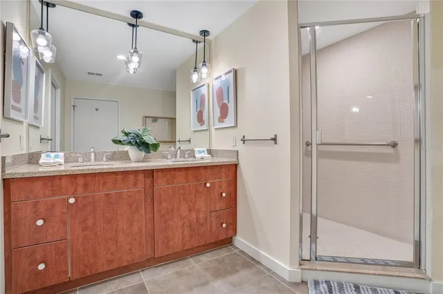 a bedroom with a bed and a wooden floor