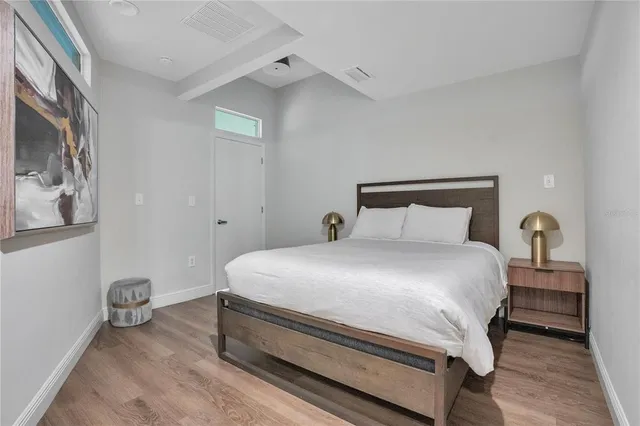 a bathroom with a sink a toilet a mirror and shower curtain