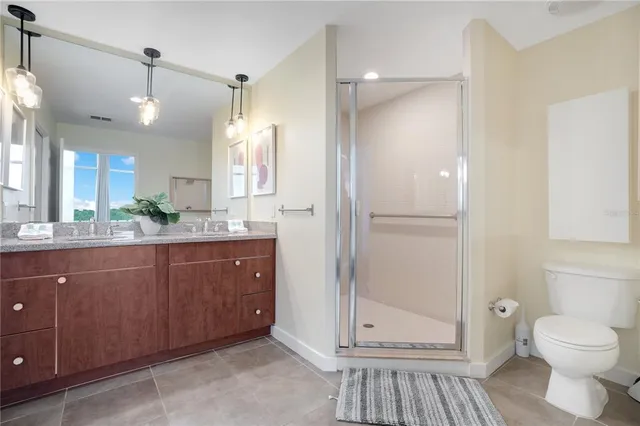 a spacious bedroom with a bed and a ceiling fan