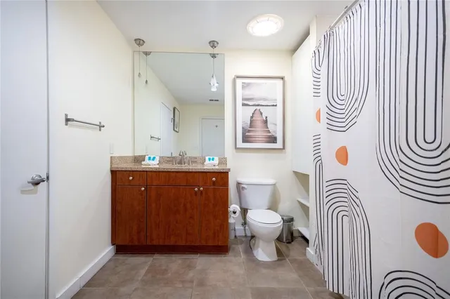 a dining room with furniture and a floor to ceiling window
