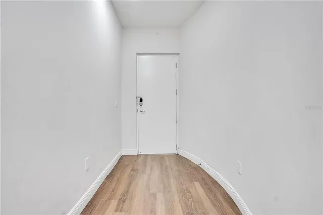 a view of a kitchen with kitchen island stainless steel appliances wooden floor and window