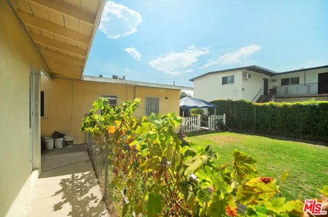 a front view of a house with a yard and fountain