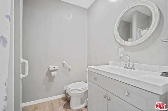 a bathroom with a sink a toilet and a mirror