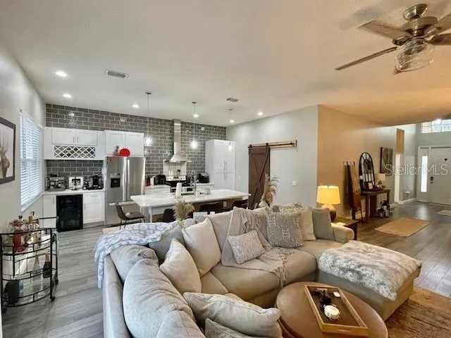 a living room with furniture kitchen and a fireplace