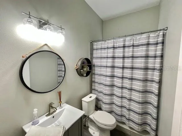 a bathroom with a sink a mirror and a toilet