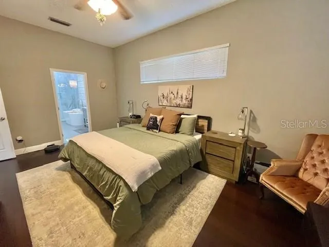 a bedroom with bed and a chandelier