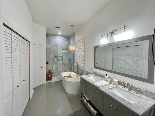 a bathroom with a double vanity sink mirror and toilet