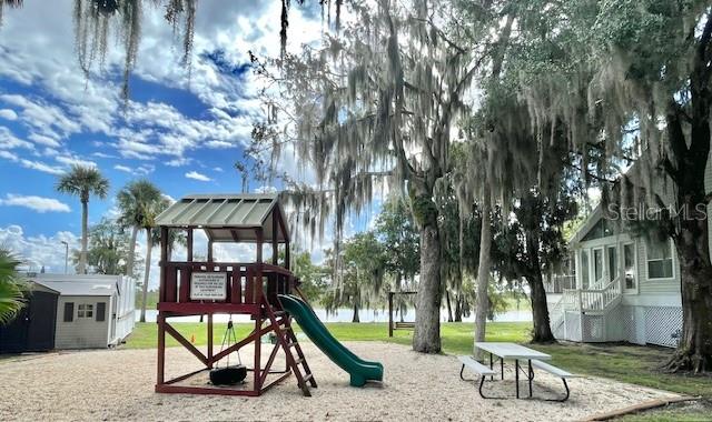 226 River Village Drive DeBary, FL 32713 - Photo 23 of 27 a view of a park with swings and slides