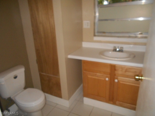 1419 Mandel Road Fort Myers, FL 33919 - Photo 12 of 18 a bathroom with a sink a toilet and a mirror