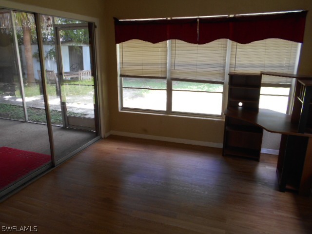 1419 Mandel Road Fort Myers, FL 33919 - Photo 14 of 18 a room that has a bed window and wooden floor