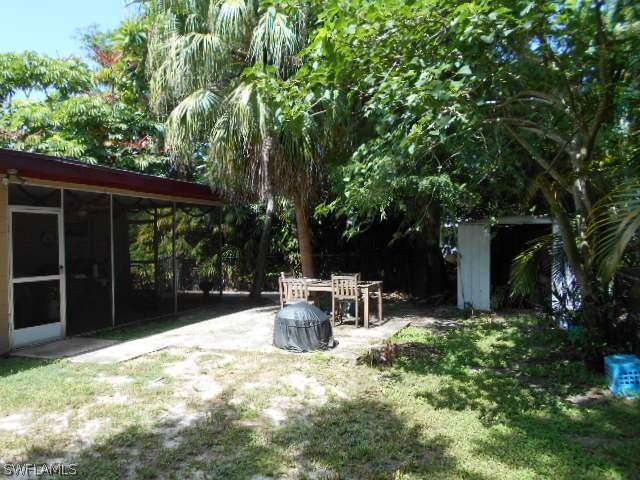 1419 Mandel Road Fort Myers, FL 33919 - Photo 18 of 18 a view of a chair and table in backyard of the house