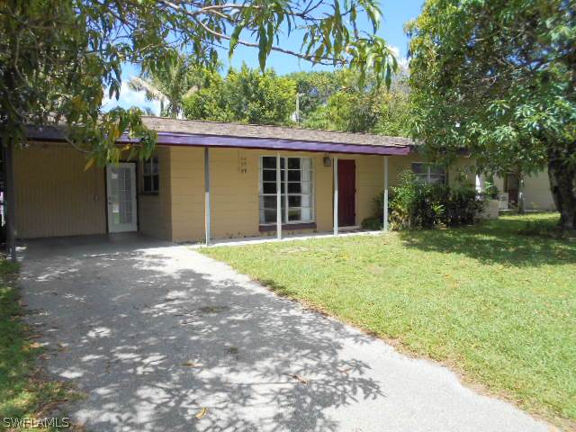 1419 Mandel Road Fort Myers, FL 33919 - Photo 2 of 18 a view of a house with a yard and large tree