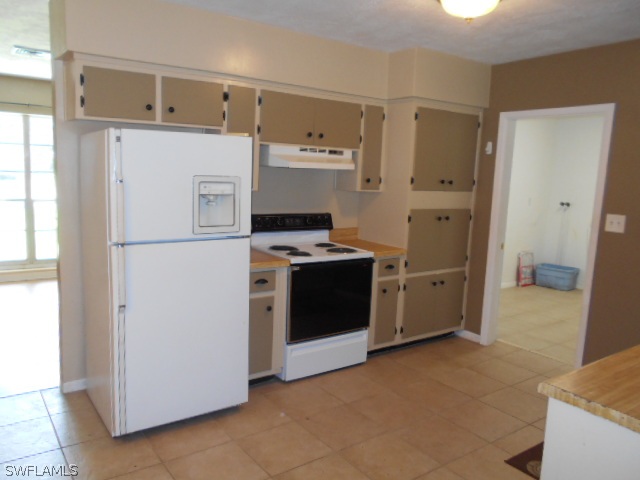 1419 Mandel Road Fort Myers, FL 33919 - Photo 4 of 18 a kitchen with stainless steel appliances a refrigerator sink and cabinets