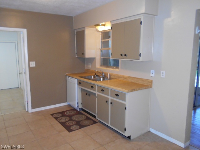 1419 Mandel Road Fort Myers, FL 33919 - Photo 5 of 18 a kitchen with a stove and a sink