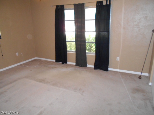 1419 Mandel Road Fort Myers, FL 33919 - Photo 9 of 18 an empty room with windows and entrance