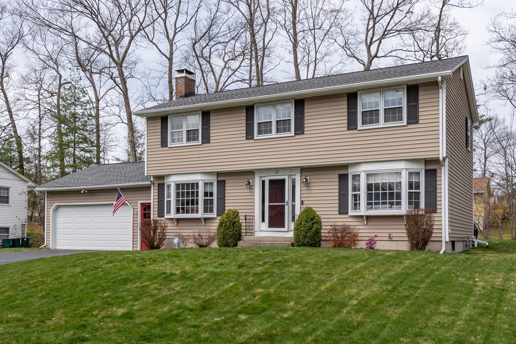 21 Nova Road Nashua, NH 03064 - Photo 1 of 30 a front view of a house with a yard and garage