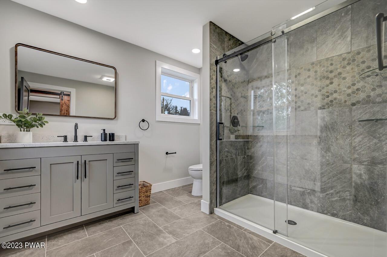 16 Pond Road Moscow, PA 18444 - Photo 37 of 55 a bathroom with a double vanity sink toilet mirror and shower
