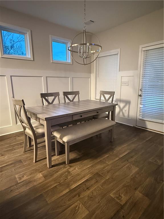 358 Mulberry Road Winder, GA 30680 - Photo 4 of 21 a view of a dining room with furniture a chandelier and wooden floor