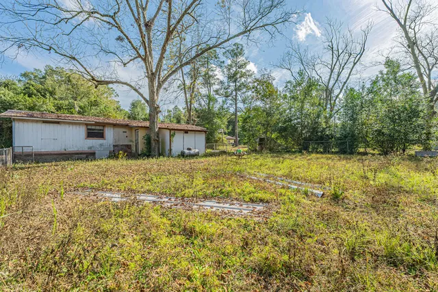 a house view with swimming pool in front of it