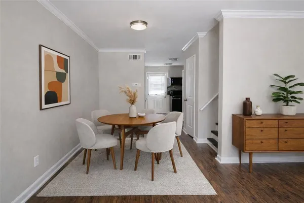 a view of a dining room with furniture and wooden floor
