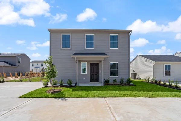 a front view of house with yard and green space