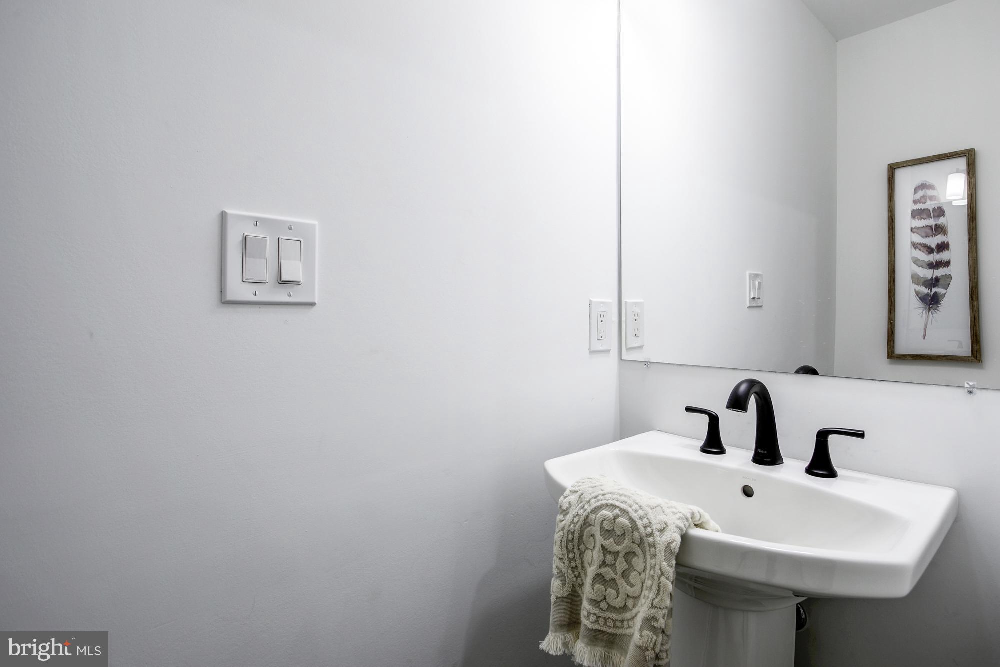 1730 Montello Avenue Northeast, Unit 2 Washington, DC 20002 - Photo 8 of 14 a bathroom with a sink and a mirror