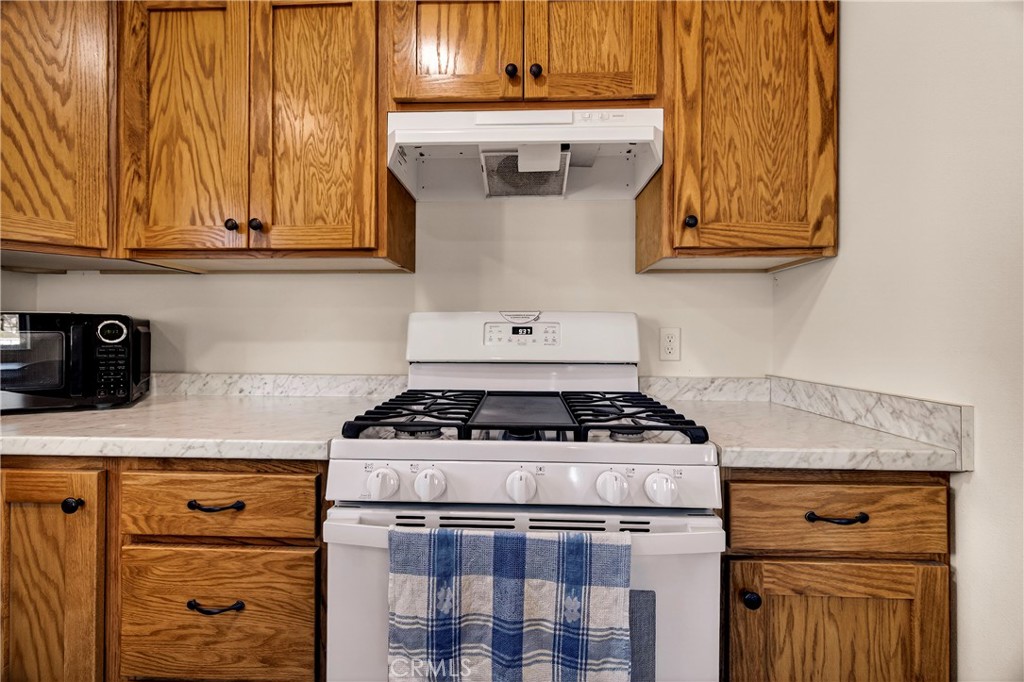 6352 Tahoe Court Paradise, CA 95969 - Photo 15 of 61 a stove top oven sitting inside of a kitchen and granite counter tops