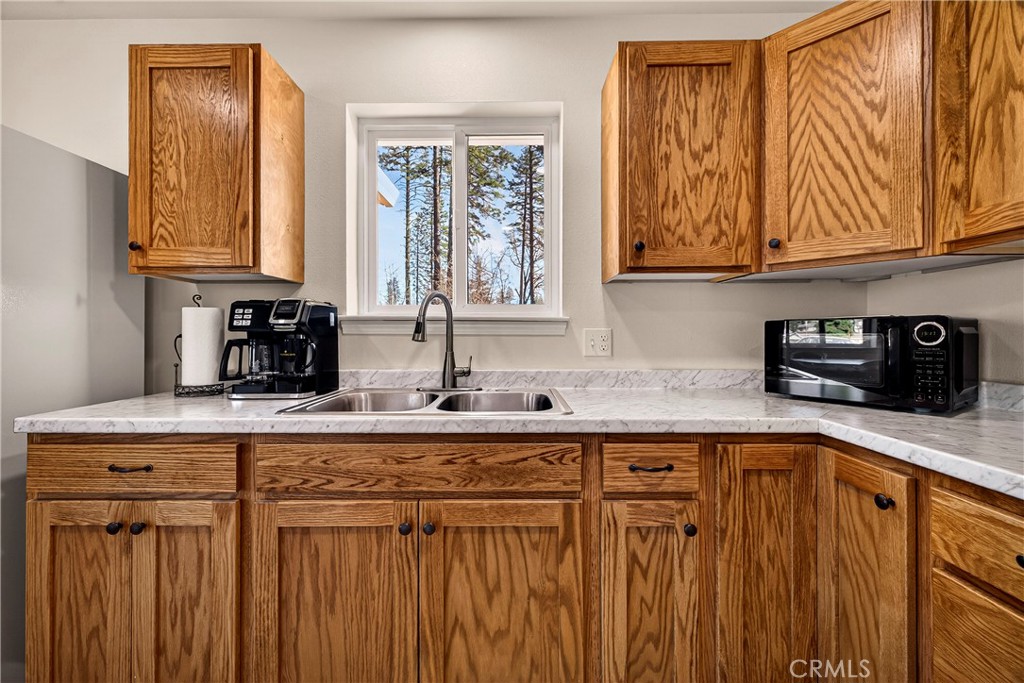 6352 Tahoe Court Paradise, CA 95969 - Photo 16 of 61 a kitchen with stainless steel appliances granite countertop a sink a stove cabinets and a dining table with wooden floor