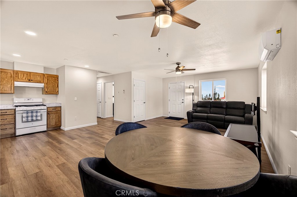 6352 Tahoe Court Paradise, CA 95969 - Photo 17 of 61 a living room with couches and kitchen view with wooden floor