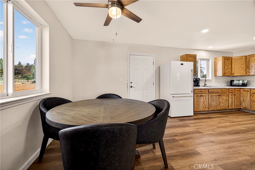 6352 Tahoe Court Paradise, CA 95969 - Photo 18 of 61 a kitchen with a table chairs refrigerator and microwave