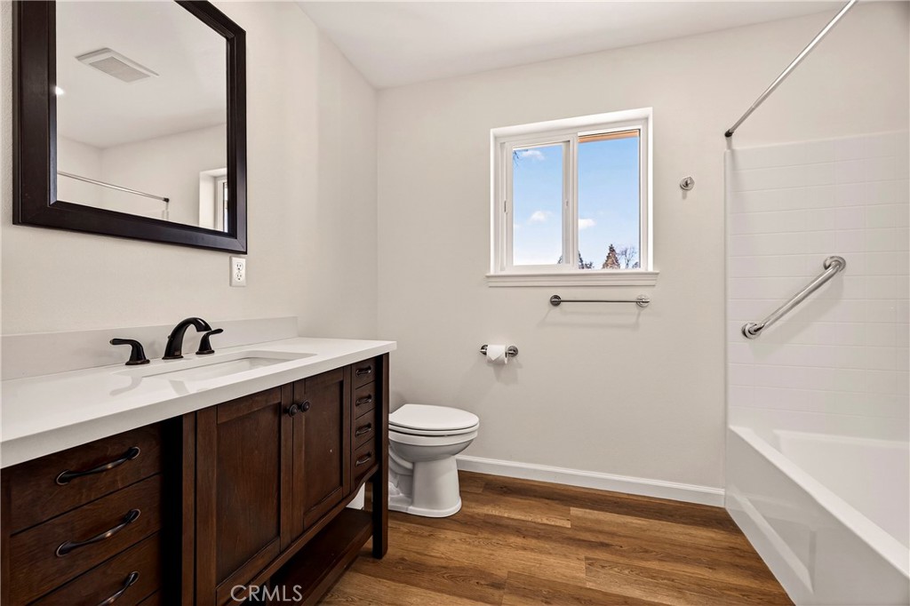 6352 Tahoe Court Paradise, CA 95969 - Photo 24 of 61 a bathroom with a toilet a sink a vanity and mirror
