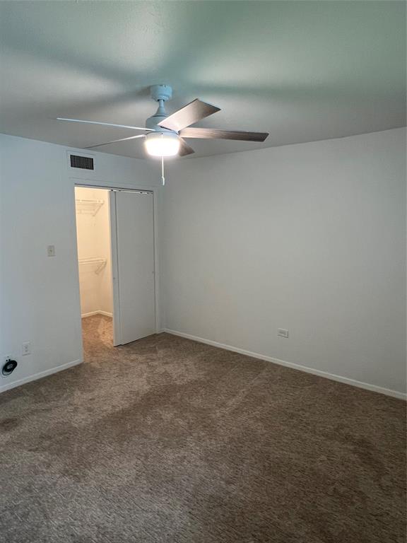 3929 Inwood Road, Unit 2021 Dallas, TX 75209 - Photo 10 of 24 Ceiling fan with integrated lighting, wall-to-wall carpeting, and a built-in closet with sliding doors