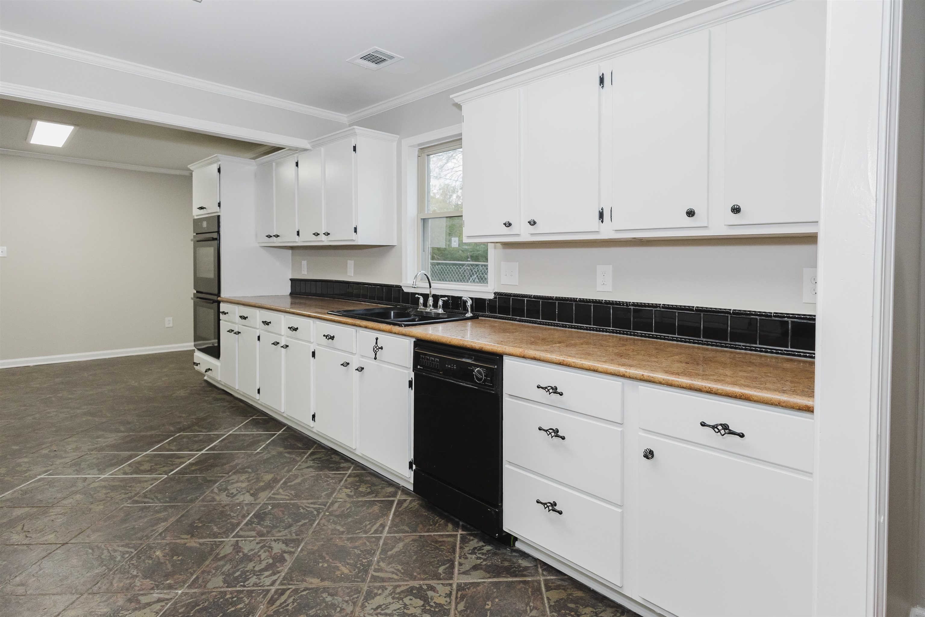 421 McDermitt Road Memphis, TN 38120 - Photo 6 of 23 a kitchen with granite countertop white cabinets and white appliances